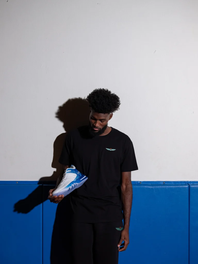 Jonathan Isaac holding his Judah 1 shoe
